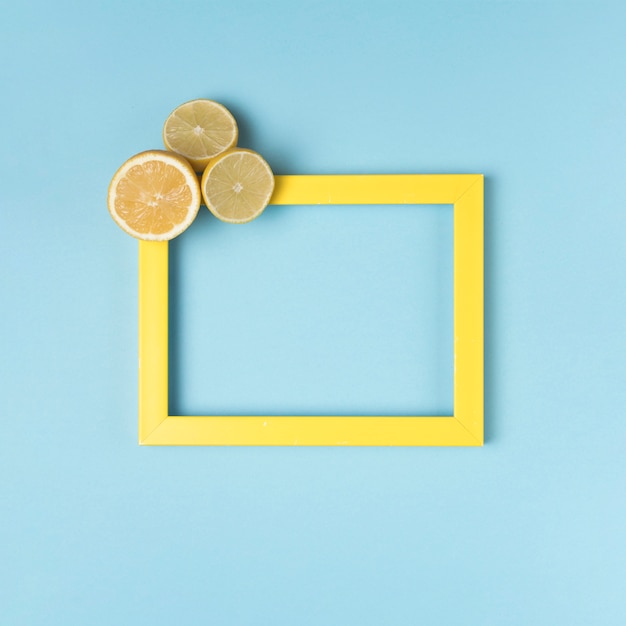 Free Photo yellow frame with cut lemons