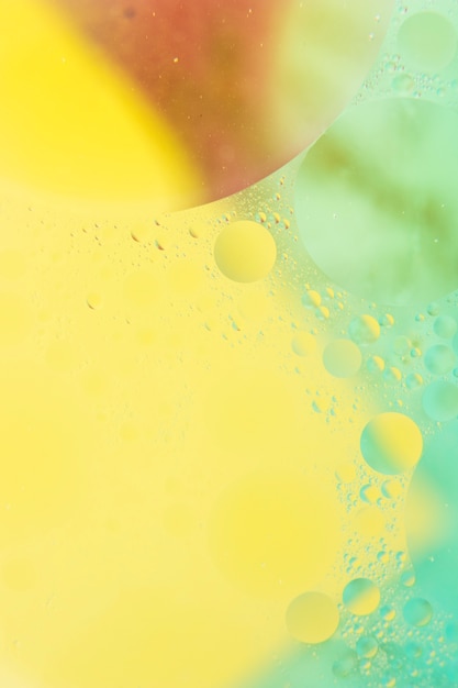 Free photo yellow and green painted background with bubbles pattern