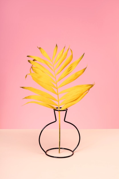 Free Photo yellow leaf in dark vase