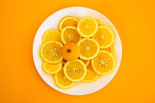 Yellow lemons on a plate on a sunny day