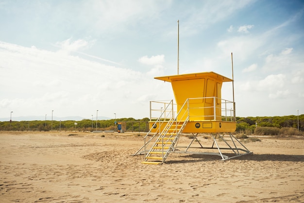 Yellow lifeguard post onn empty beach