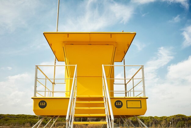 Yellow lifeguard post onn empty beach