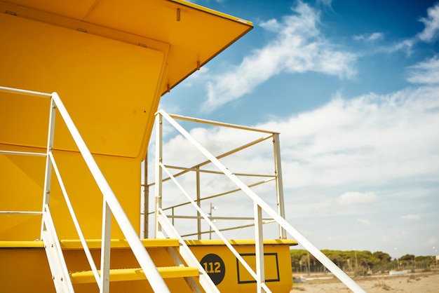 Yellow lifeguard post onn empty beach