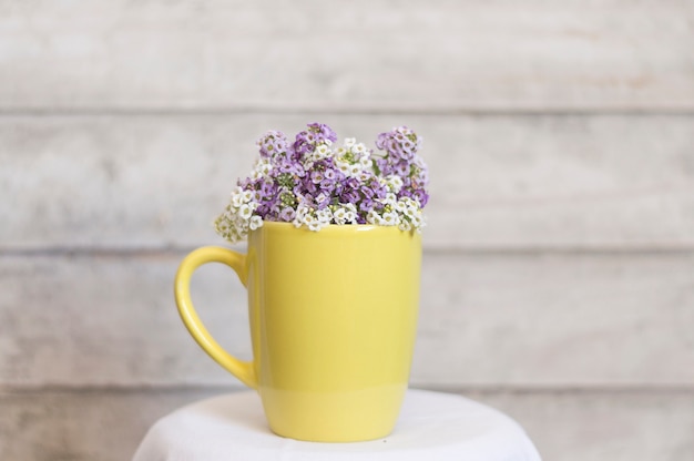 Yellow mug with purple and white flowers