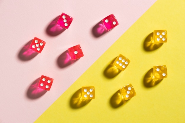 Free Photo yellow and pink dices on colorful background