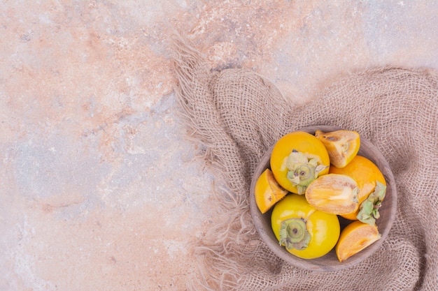 Free photo yellow plum dates in a wooden tray.