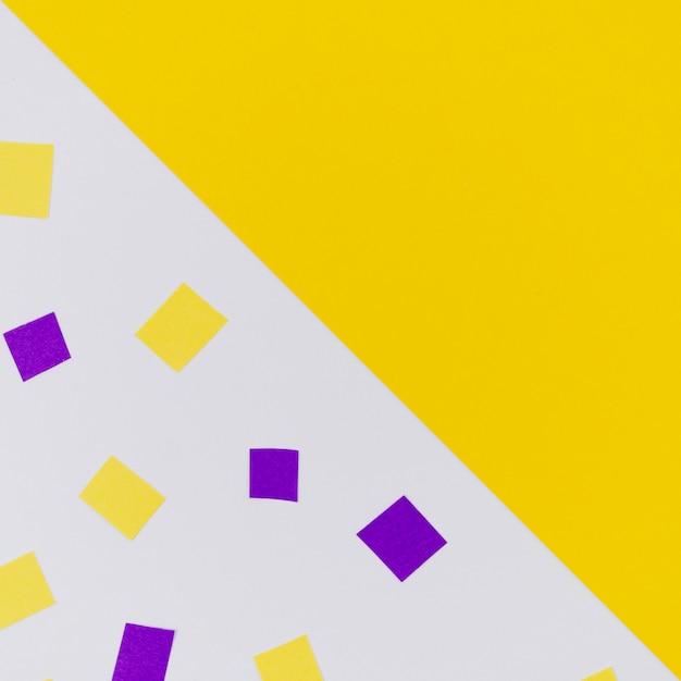 Free Photo yellow and purple confetti with copy space