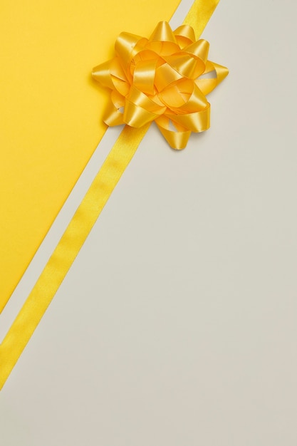 Free photo yellow ribbon on yellowish background