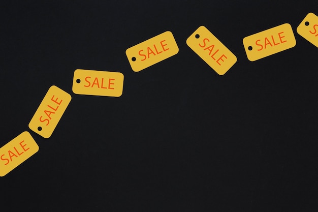 Free Photo yellow sale tags on dark background