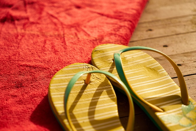 Free Photo yellow sandals on a red towel