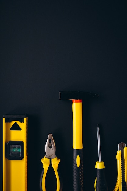 Free photo yellow set of tools on black background