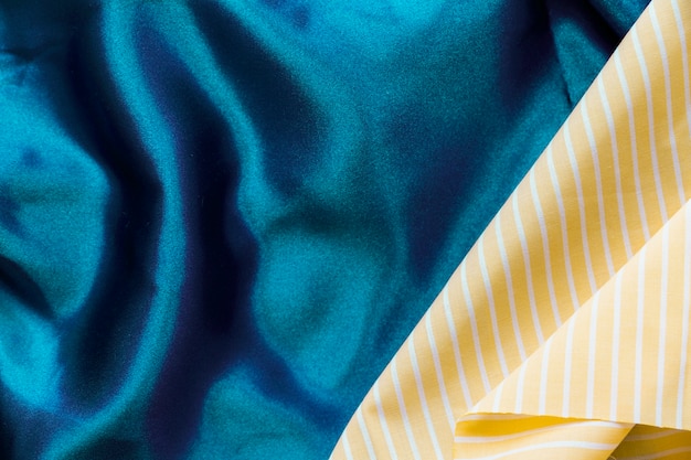 Free photo yellow stripes pattern on plain blue textile background