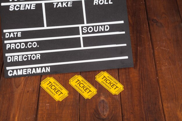 Free Photo yellow tickets near clapperboard