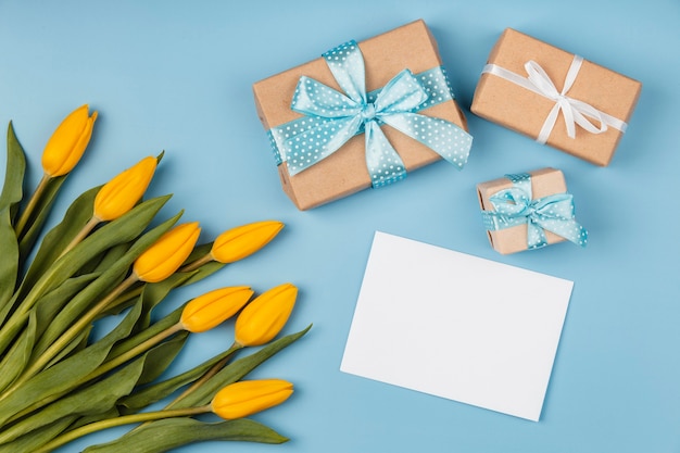 Yellow tulips with blank card and gifts