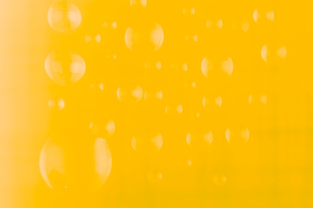 Free photo yellow water drop background