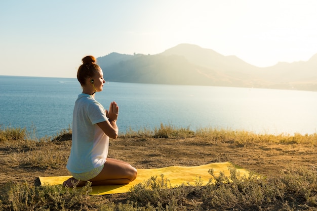 Yoga girl with wireless headphones