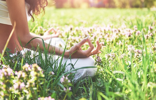 Free Photo yoga meditation in a park on the grass is a healthy woman at rest.