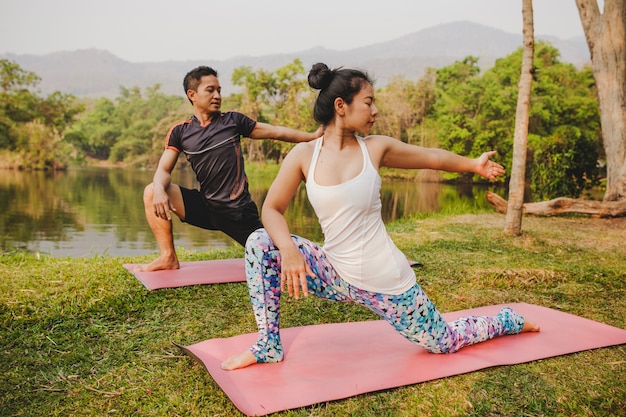 Yoga partners in the middle of the nature