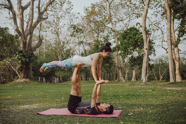 Yoga partners with difficult and acroatic pose