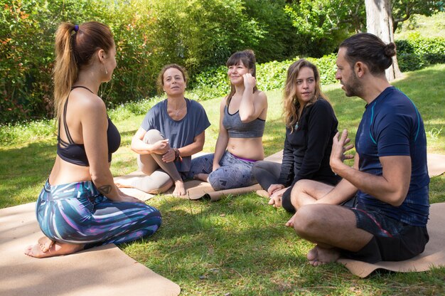 Yoga trainer instructing trainees