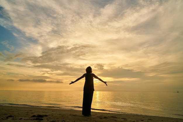 Free photo yoga and woman on the beach