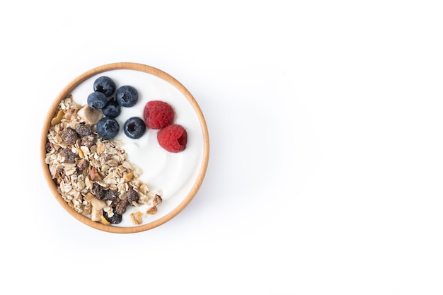 Yogurt with berries and muesli for breakfast in bowl isolated on white background