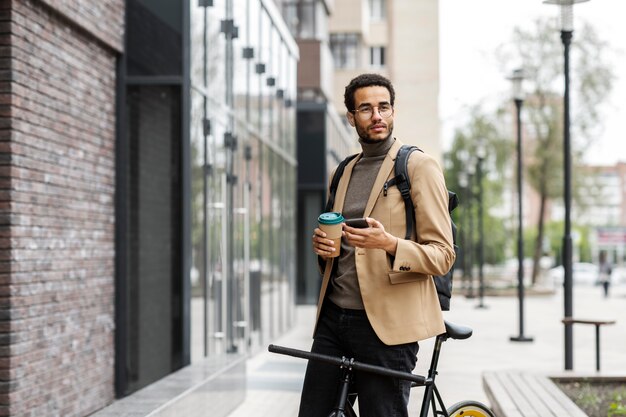 Young adult cycling to work in the city