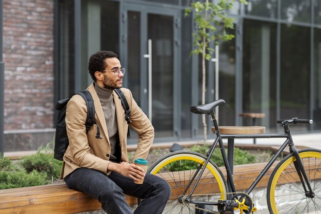 Young adult cycling to work in the city