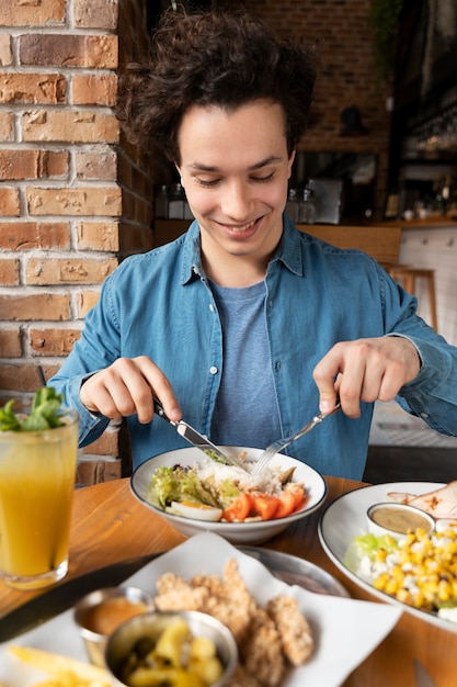 Free photo young adult enjoying food