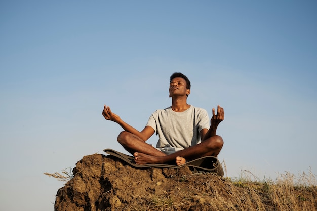 Young adult enjoying yoga in nature