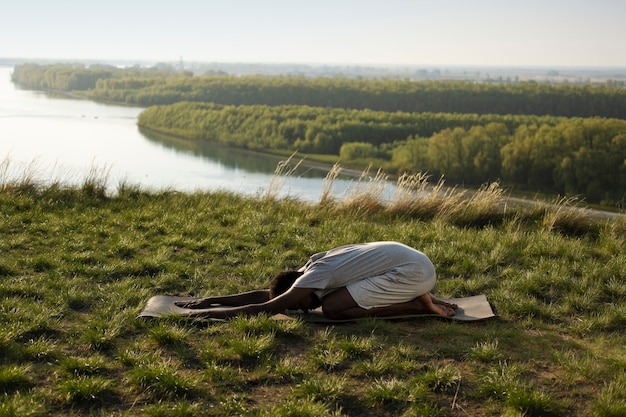 Free Photo young adult enjoying yoga in nature