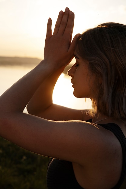 Young adult enjoying yoga in nature