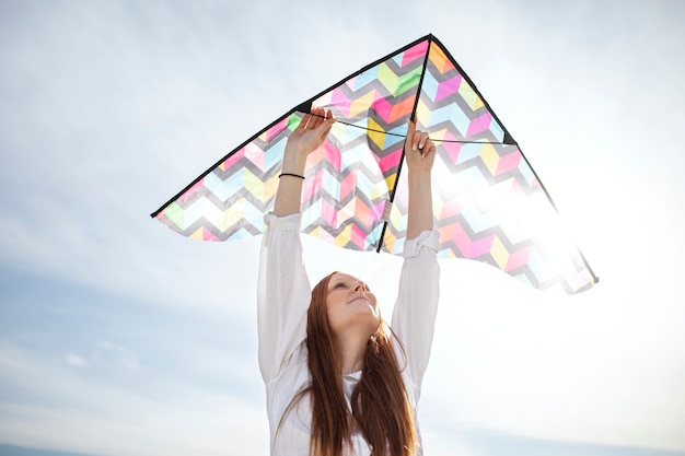 Free photo young adult having fun with kite