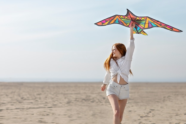 Free photo young adult having fun with kite