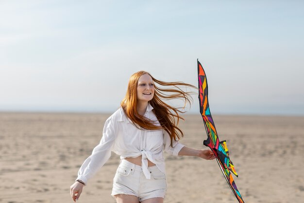 Young adult having fun with kite