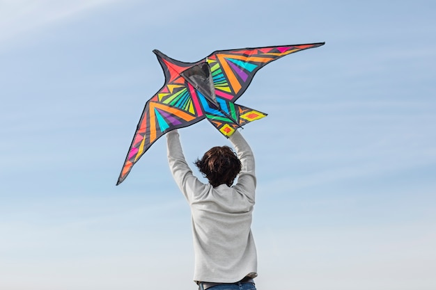 Free photo young adult having fun with kite