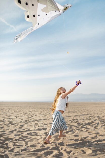 Young adult having fun with kite