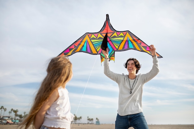 Free photo young adult having fun with kite