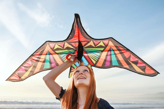 Free photo young adult having fun with kite