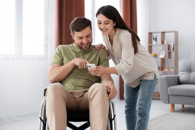 Young adult helping disabled friend