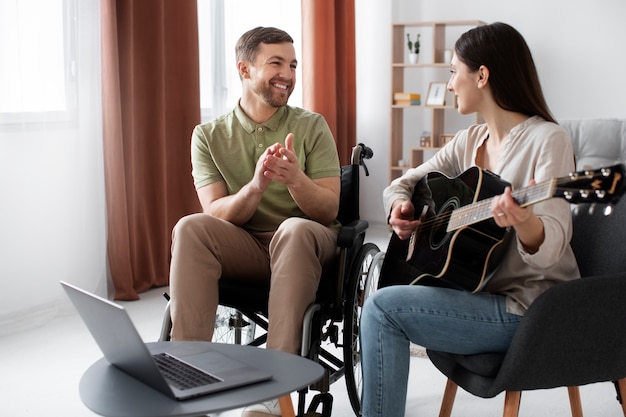 Young adult helping disabled friend