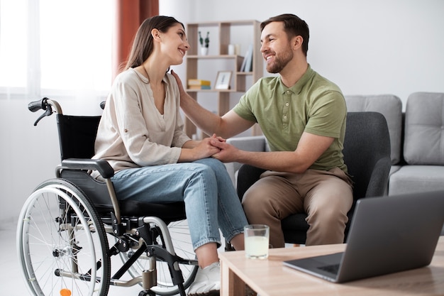 Young adult helping disabled friend