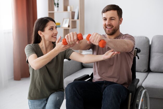 Young adult helping disabled friend