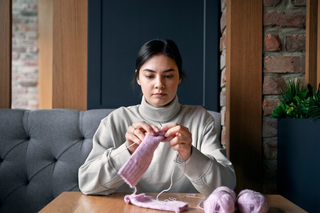 Young adult knitting outside