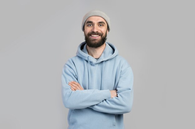 Young adult man wearing hoodie and beanie