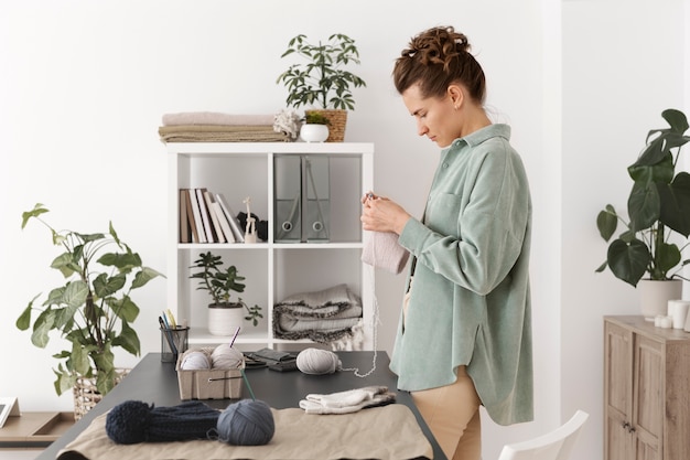 Young adult organizing their knitting products