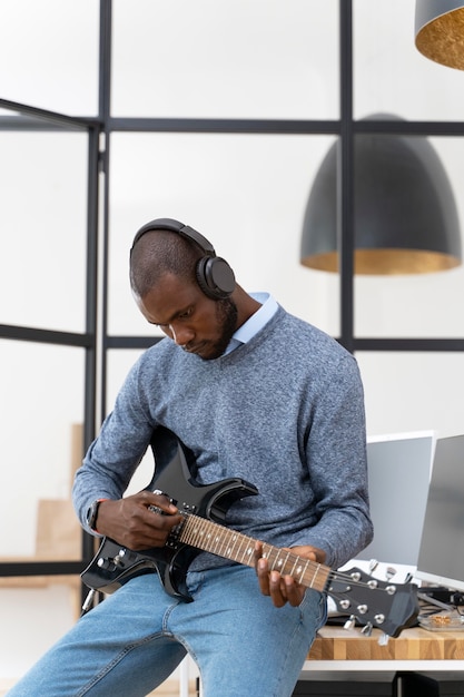 Free Photo young adult playing the guitar