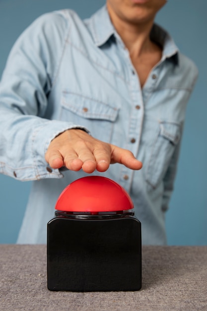 Young adult pressing buzzer button