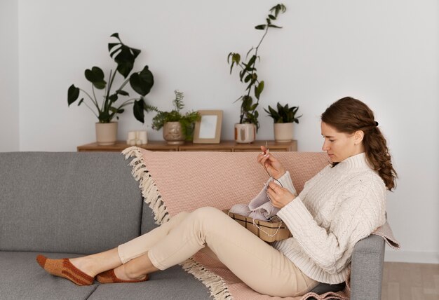 Young adult relaxing while knitting