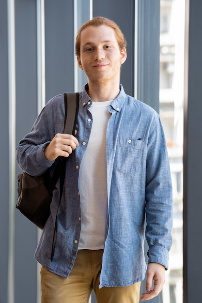 Free photo young adult smiling while waiting for his friends